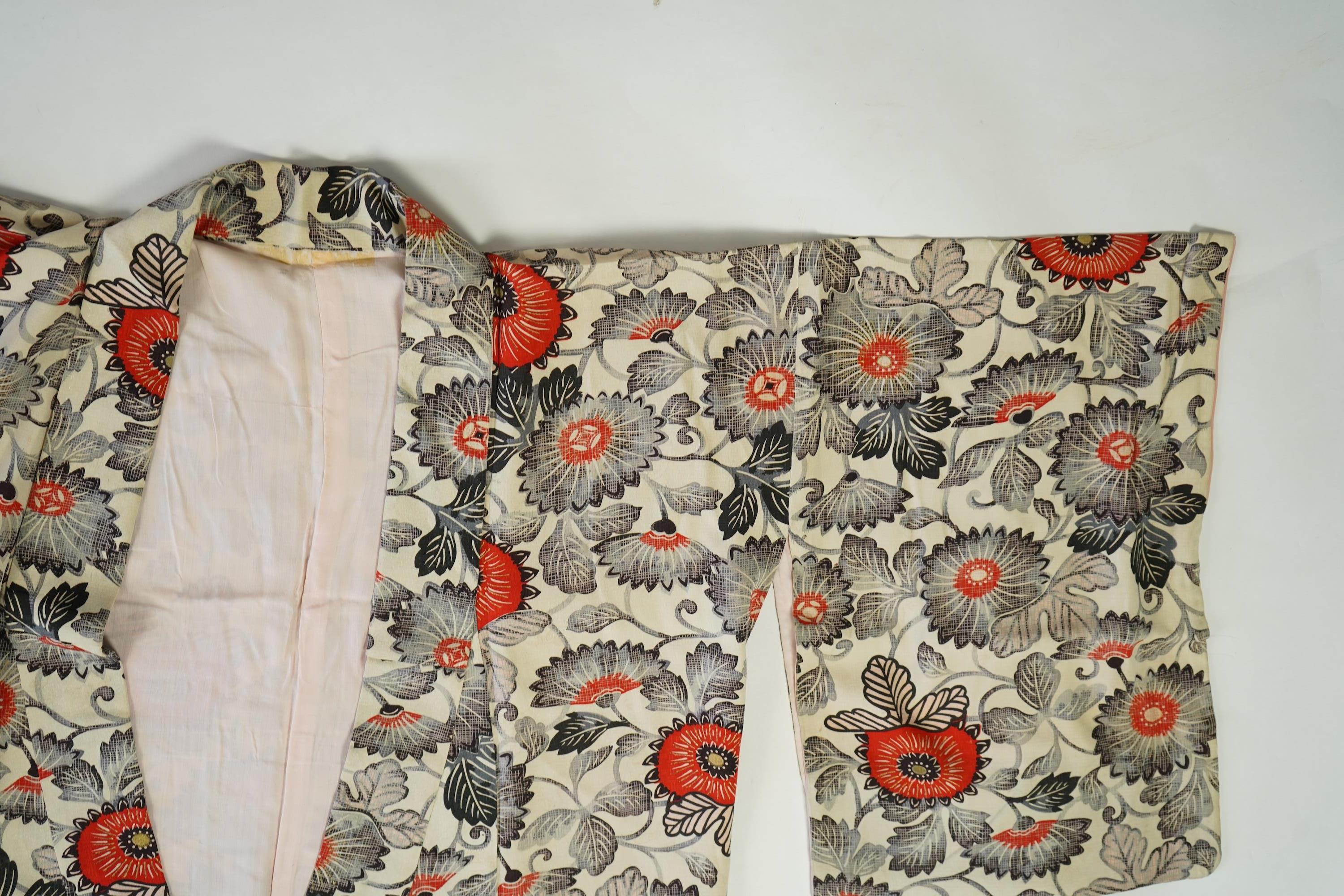 Four 1930’s - 1950’s printed silk full length silk lined Japanese kimonos. Two floral and two geometric in design. Longest black and orange floral designed kimono, 150cm long. Condition - purple and pink check kimono the